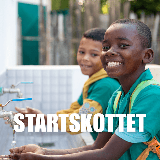 Två killar som tvättar händerna och tittar in i kameran.